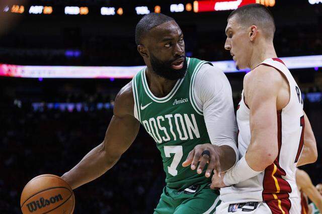Boston Celtics guard Jaylen Brown (7) looks around Miami Heat guard Tyler Herro (14) during the second half of a game on Wednesday, April 1, 2026, at the Kaseya Center in downtown Miami, Fla.